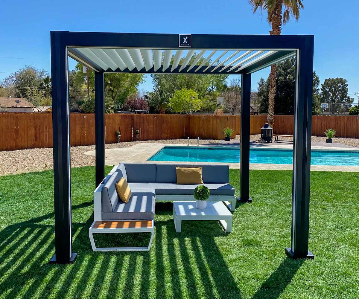 CabanaX pergola on a lawn with a pool in background
