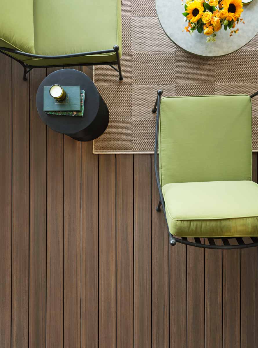 Aerial shot of Drew's green chair and a coffee table on the English Walnut decking