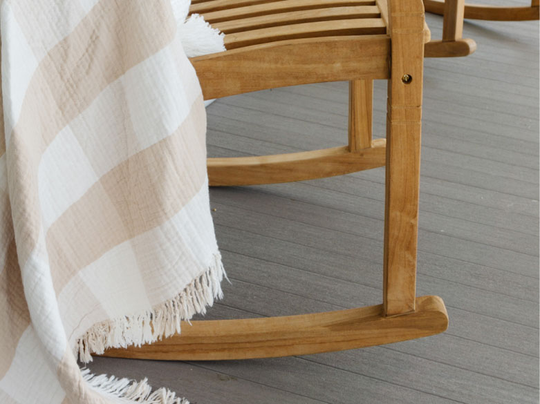Close up shot of the leg of a rocking chair on the porch built with Coastline boards