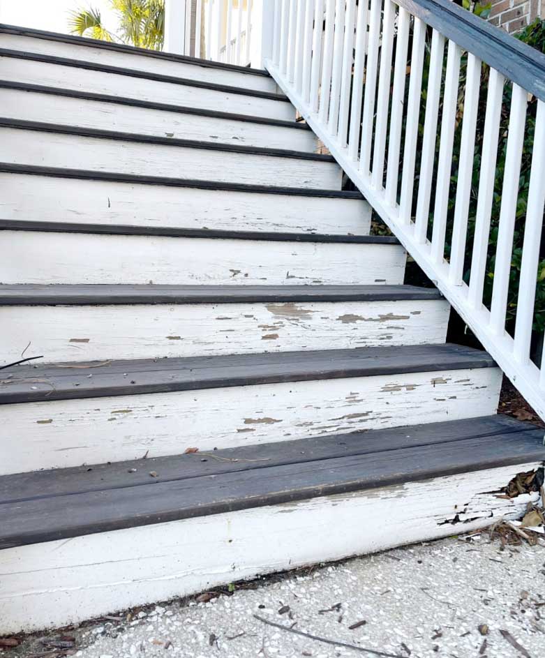 Amy's stairs before the update, paint peels off the steps and rotting wood chips off.