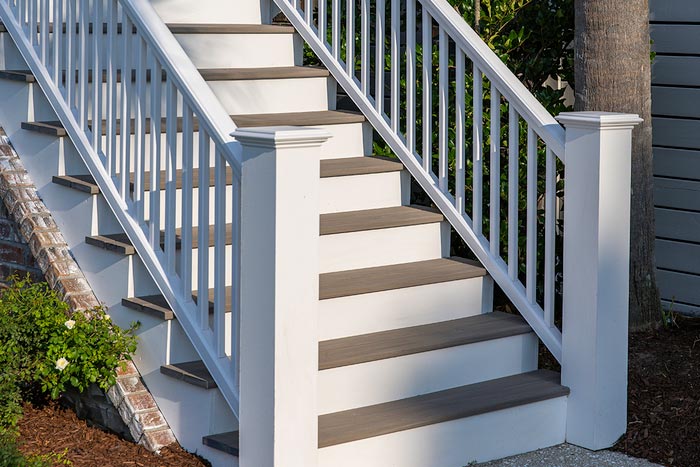 TimberTech Advanced PVC Porch stairs in Coastline with white Classic Composite Series deck railing with white balusters