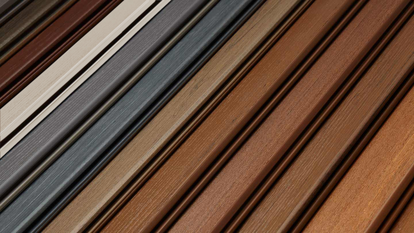 A close-up of Timbertech deck paneling ranging from light panels to dark panels. 