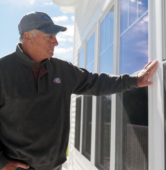 Joe Guenther looking through an external window at the Pentwater Yacht Club. 