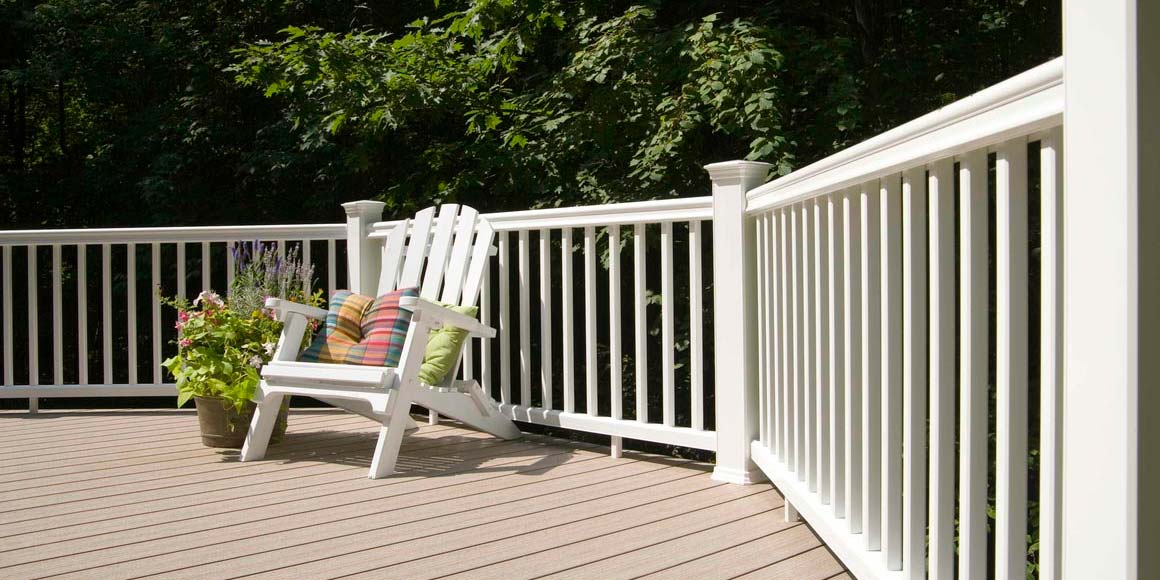 Adirondack chair on deck with RadianceRail Express railing in white