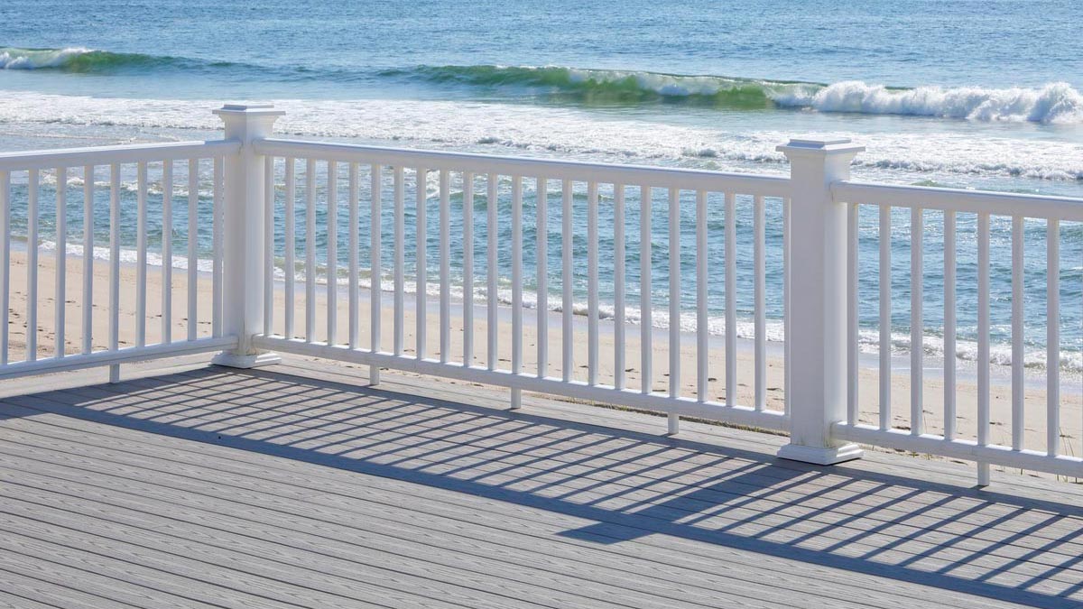 White traditional-style TimberTech railing on beachfront property