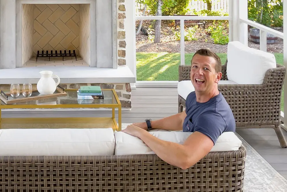 A close-up image of Philip on a wicker couch in his island getaway.