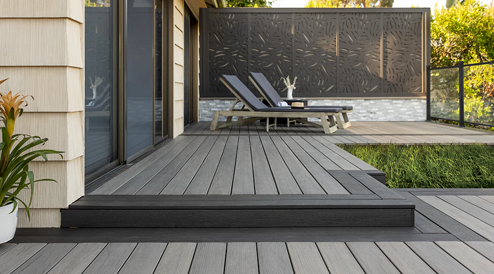 Set table on a gray deck overlooking a sandy beach