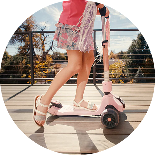 A child safely rides a scooter in open-toed shoes on a TimberTech deck